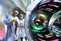 Technicians working at the semiconductor tracker for ATLAS, one of the four enormous detectors for the Large Hadron Collider at 